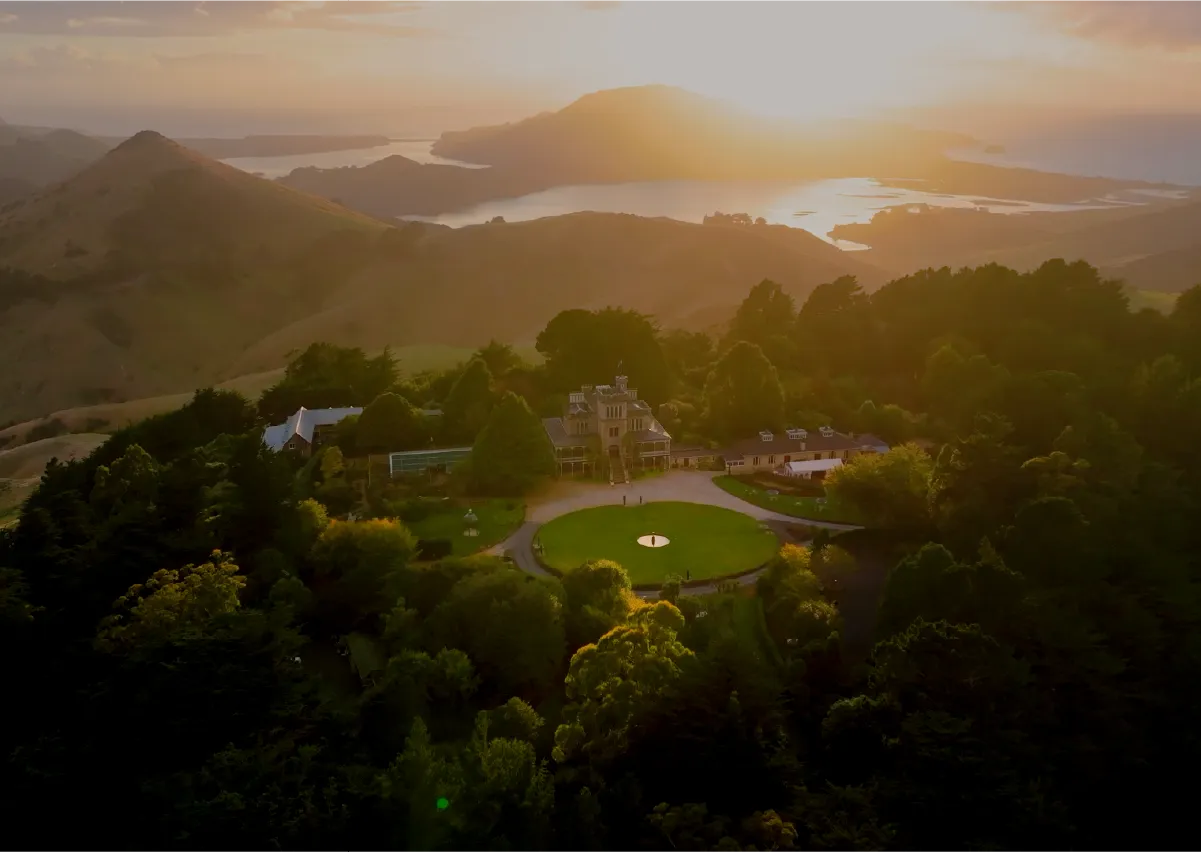 Dunedin, When the Sun Rises from the Mountain and Ocean Aerial footage of Dunedin captured at sunrise across a full year of production, from Larnach Castle and Mt Cargill to the university campus and harbour.