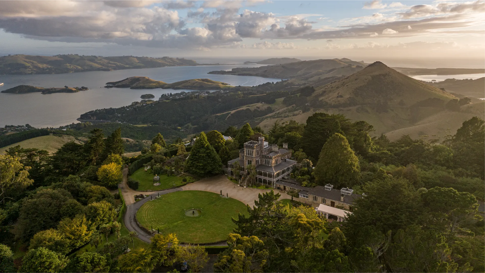 Dunedin, When the Sun Rises from the Mountain and Ocean Aerial footage of Dunedin captured at sunrise across a full year of production, from Larnach Castle and Mt Cargill to the university campus and harbour.