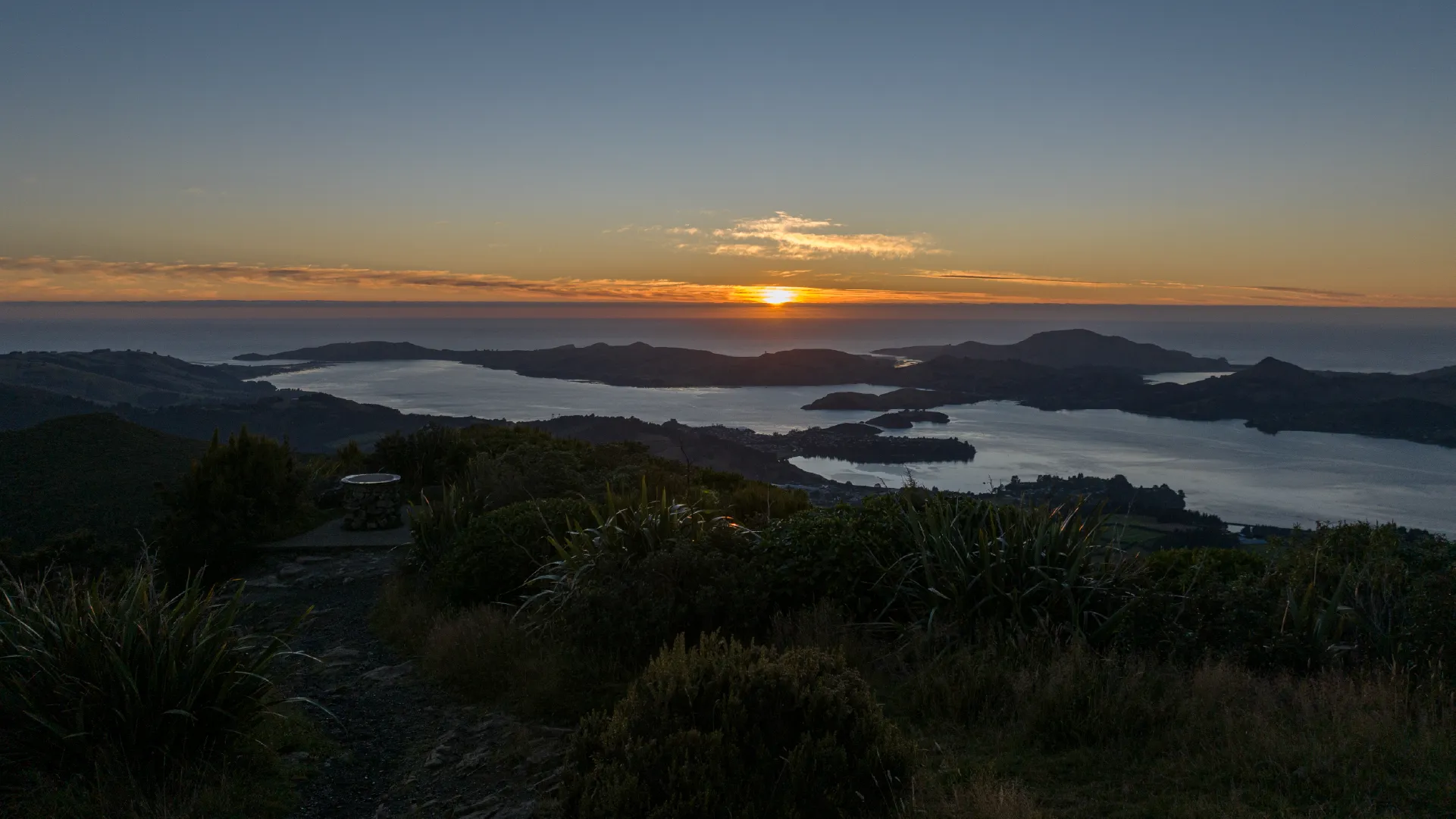 Dunedin, When the Sun Rises from the Mountain and Ocean Aerial footage of Dunedin captured at sunrise across a full year of production, from Larnach Castle and Mt Cargill to the university campus and harbour.