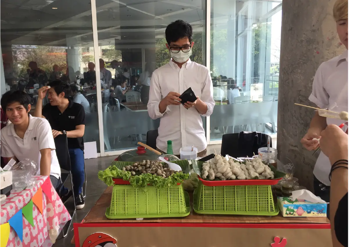 Best Uthakhamkong receiving a Best Student award or posing at Bangkok University, Thailand.