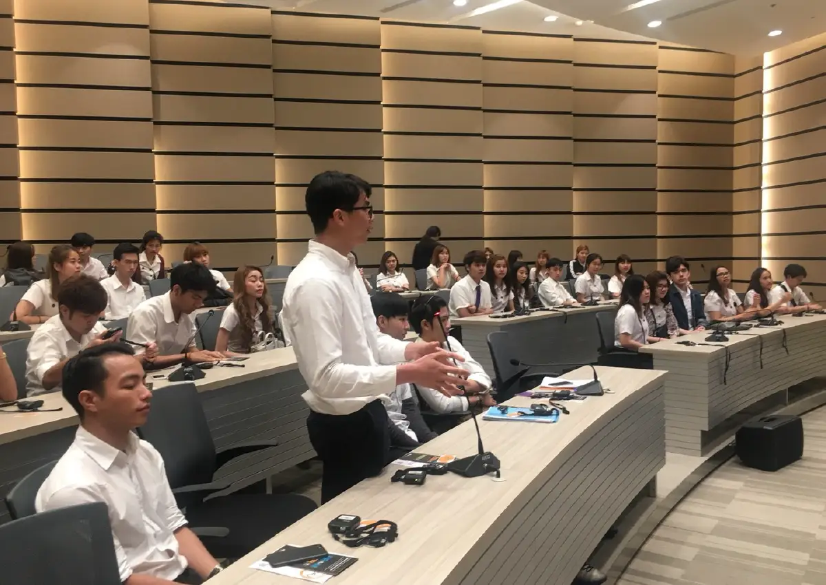 Best Uthakhamkong receiving a Best Student award or posing at Bangkok University, Thailand.